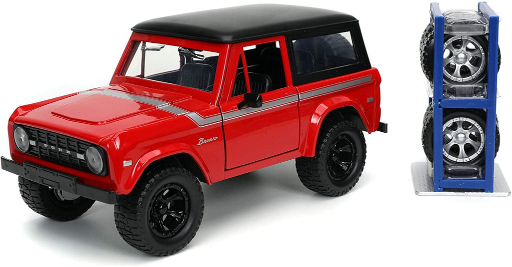 1973 Ford Bronco Red with Black Top and Silver Stripe with Extra Wheels Just Trucks Series 1/24 Diecast Model Car by Jada 32425
